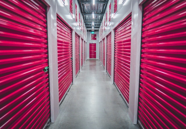 Hallway filled with red storage units.
