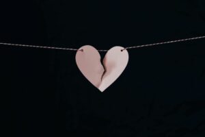 A broken pink heart on a string.